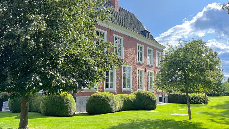 Château histórico no campo de Knokke, rodeado de vegetação